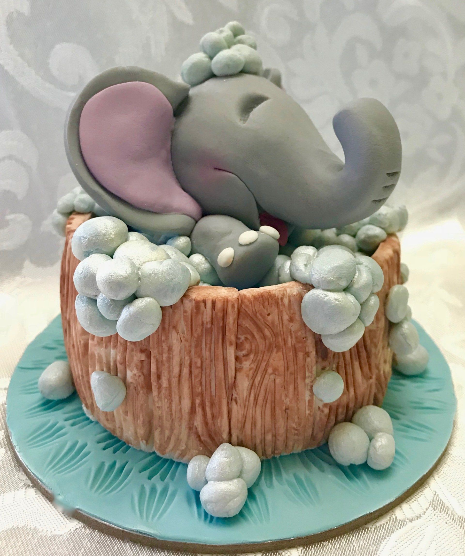 Cute Elephant splashing in a tub cake topper.