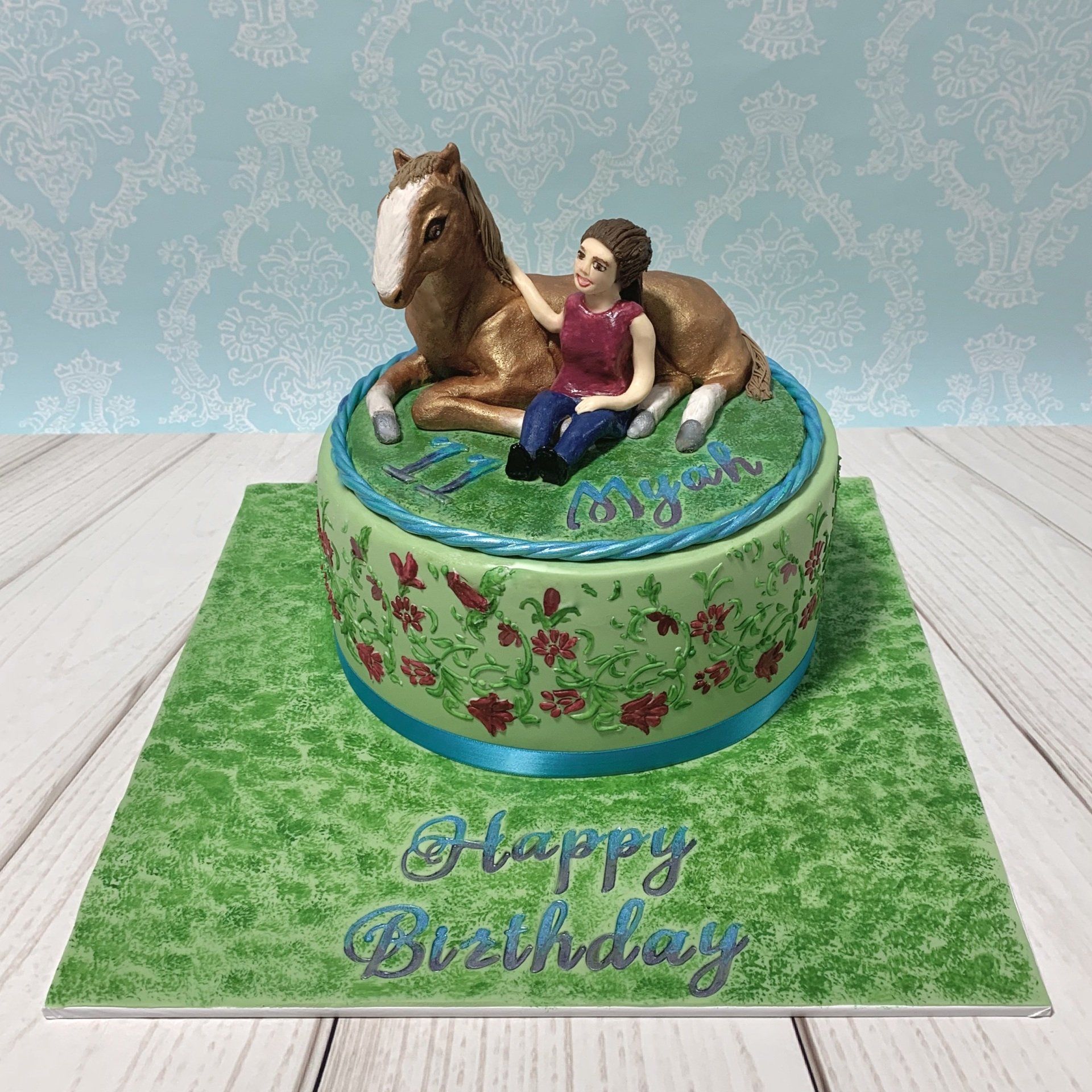 11th Birthday Cake With floral stencilling around the sides and a Handscuplted Fondant Horse and Girl on the top.