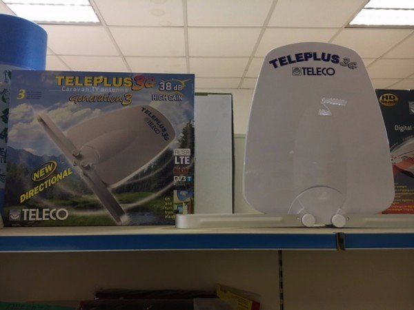 Scatola Teleplus Teleco e dispositivo bianco su uno scaffale del negozio.