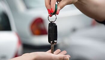 Man giving the key — used cars in Cinnaminson, NJ Man giving the key — used cars in Cinnaminson, NJ