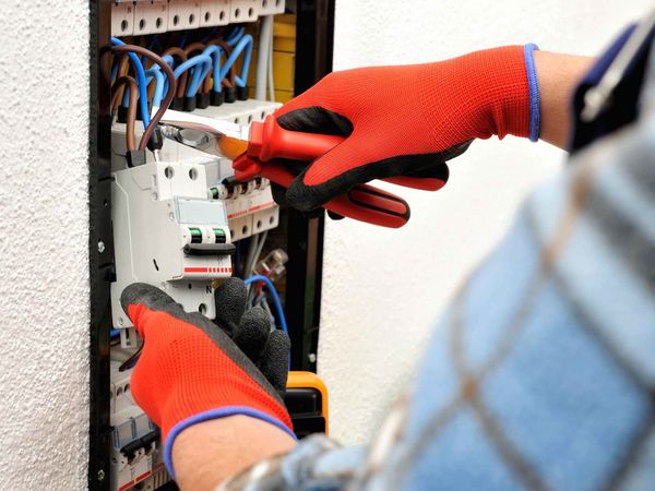 Circuit Breaker Replacement — Electrician Securing Breaker Circuit in Gainesville, FL