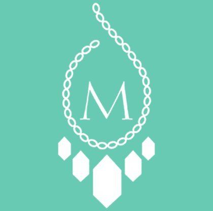 Home Logo A white necklace with the letter m on it