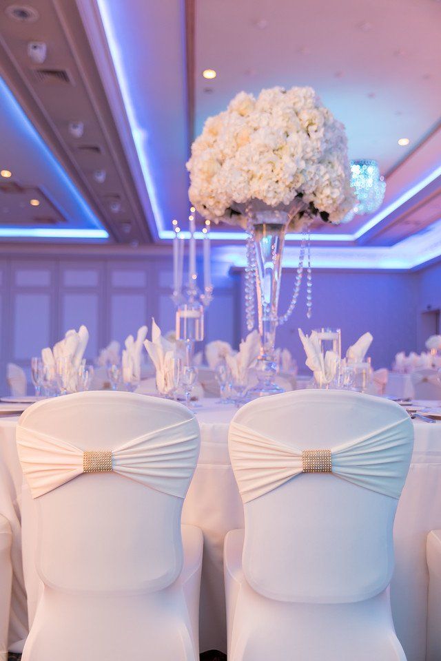 White Fabric Covered Chairs at Elegant Table