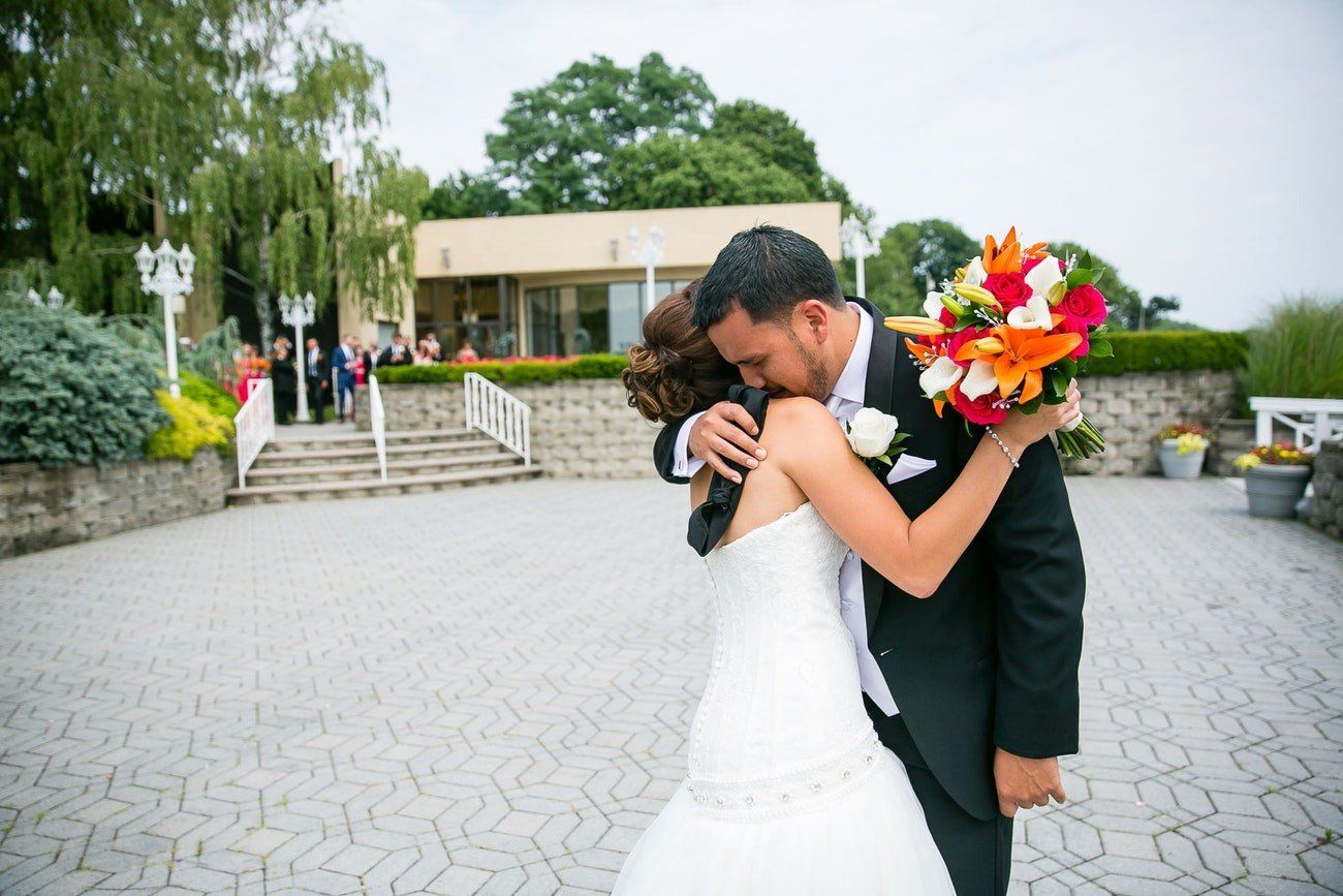 Groom Embracing Bride During First Look