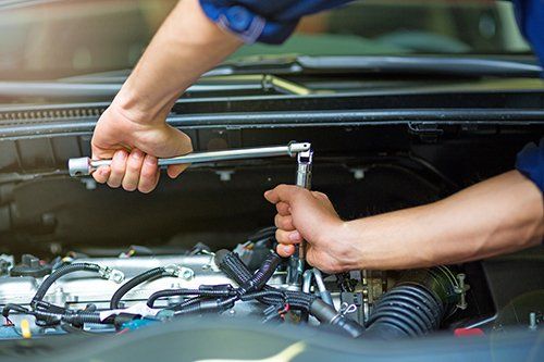 mechanic working on car engine