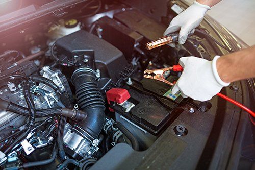 mechanic working on car engine