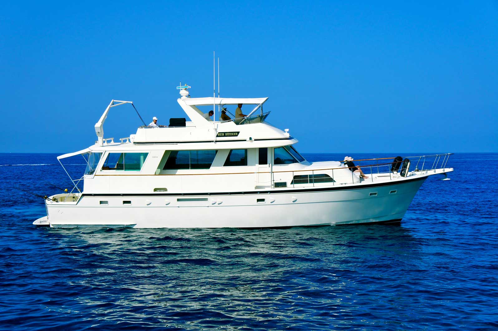 A large white boat is floating on top of a large body of water.