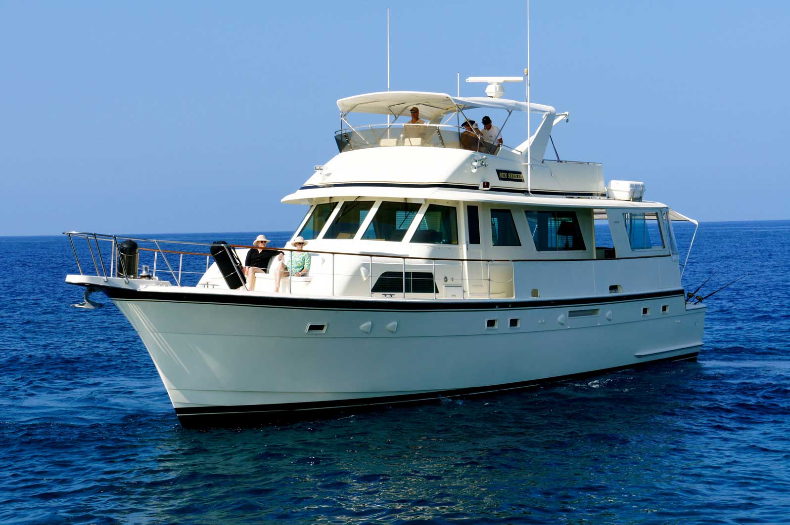 A large white boat is floating on top of a large body of water