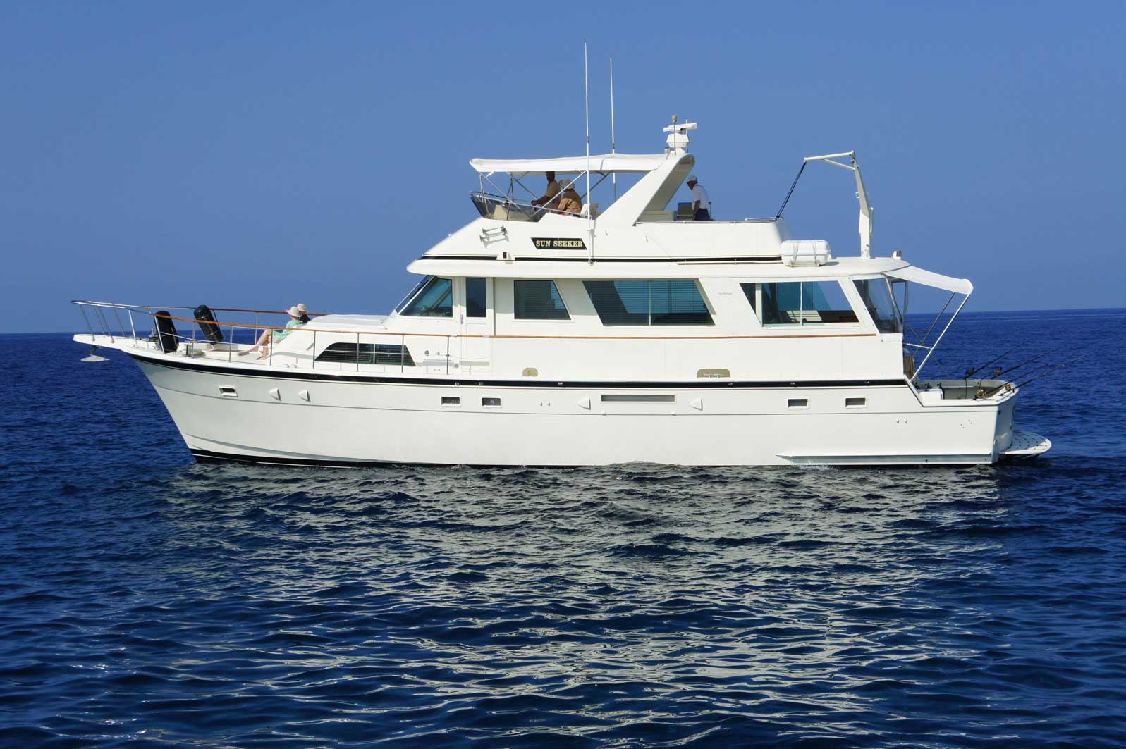 A large white boat is floating on top of a body of water.