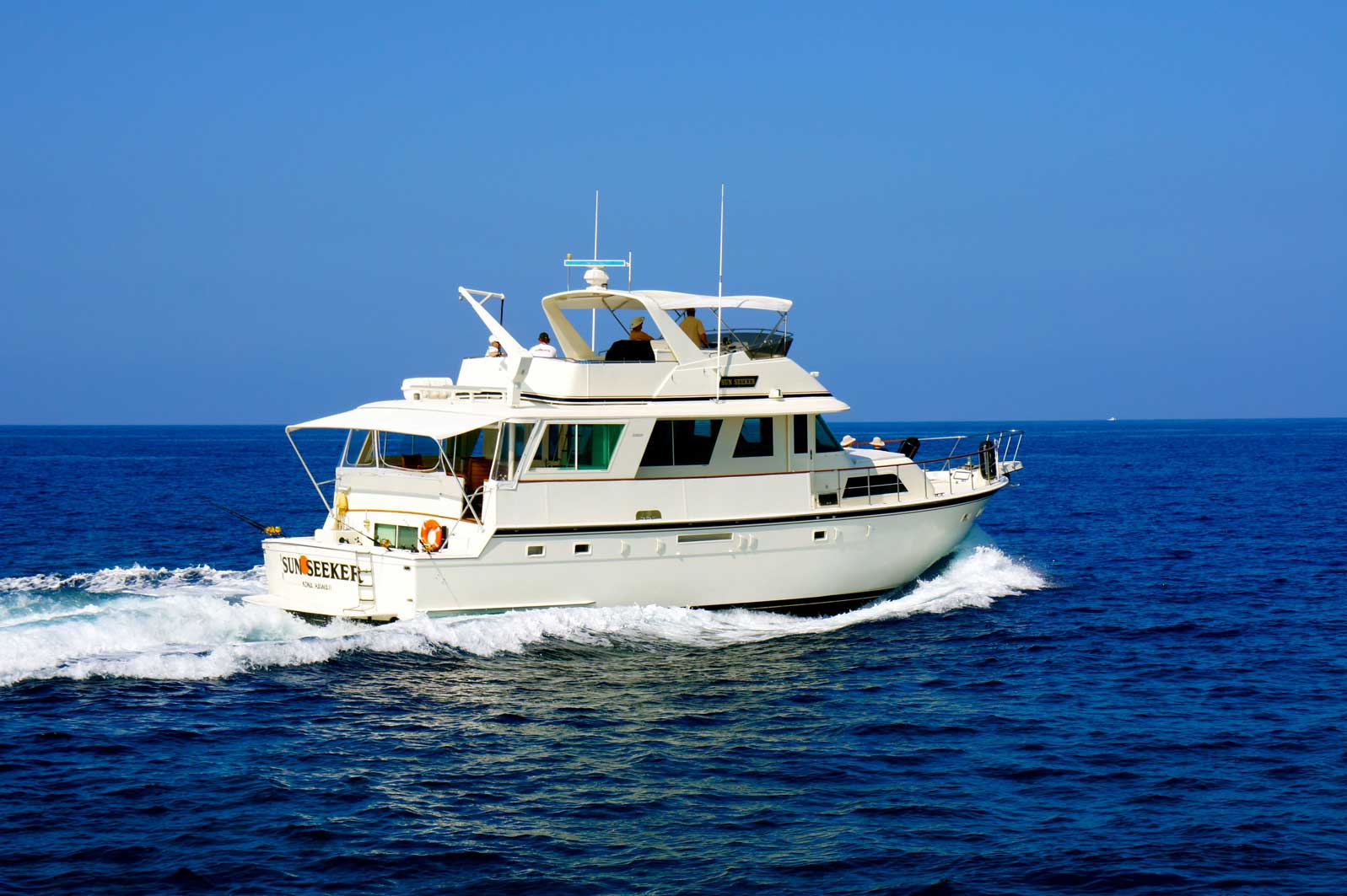 A large white boat is floating on top of a large body of water