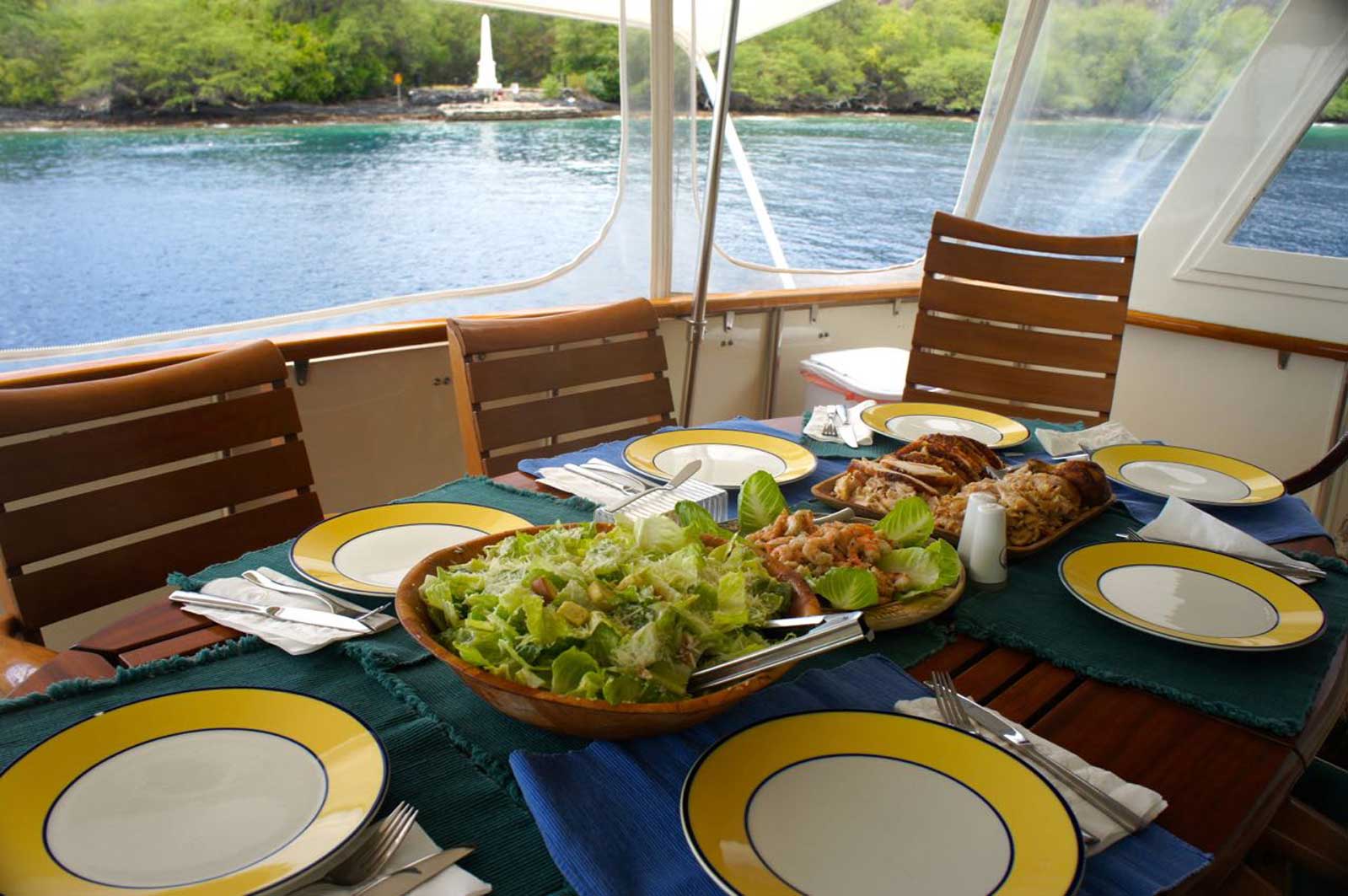 A table with plates and a bowl of salad on it