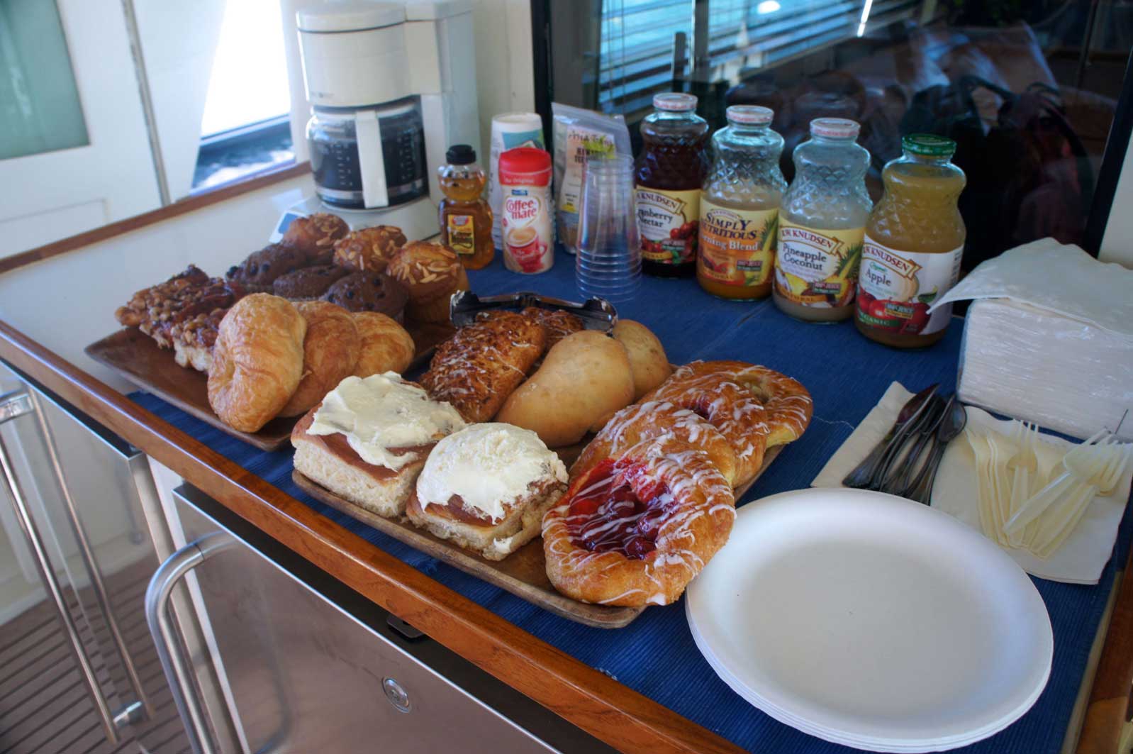A table topped with a variety of pastries and drinks.