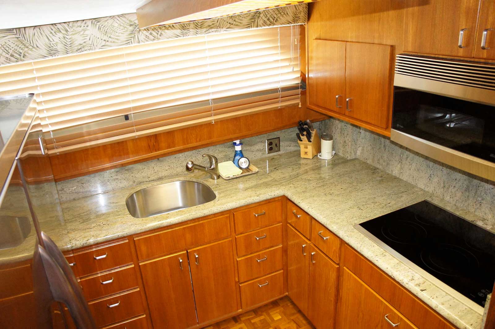 A kitchen with wooden cabinets and granite counter tops