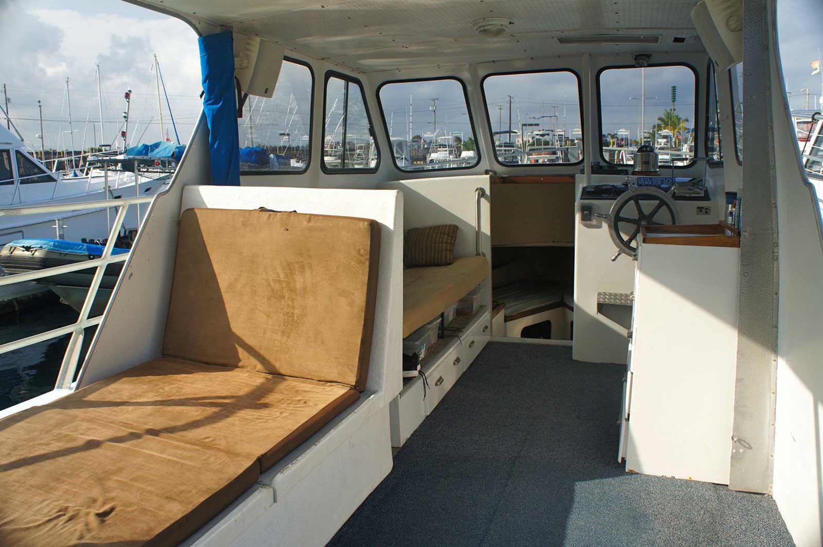 The inside of a boat with a steering wheel