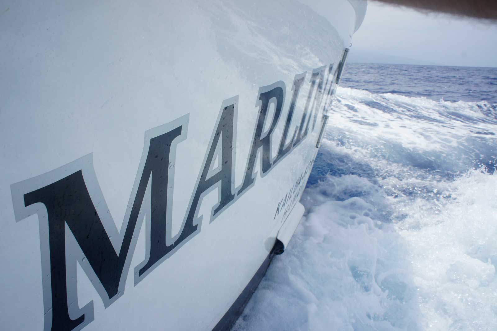 The word marlin is on the side of a boat