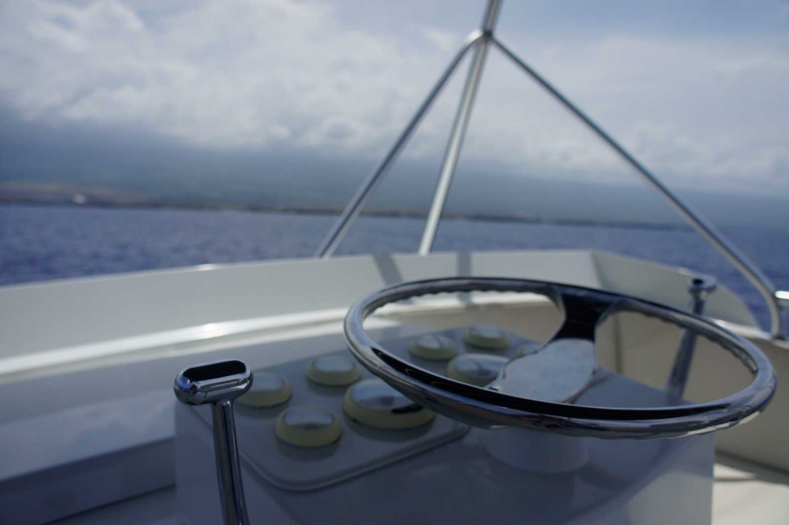 A close up of a steering wheel on a boat