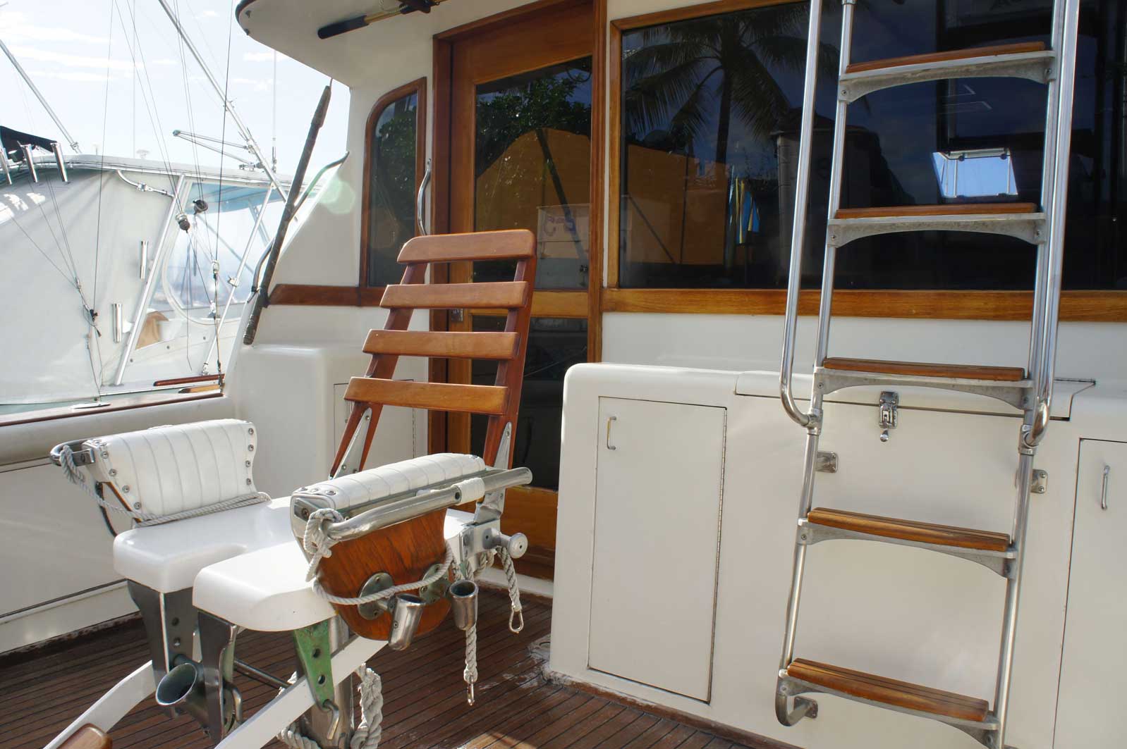 A boat with a chair and a ladder on the side