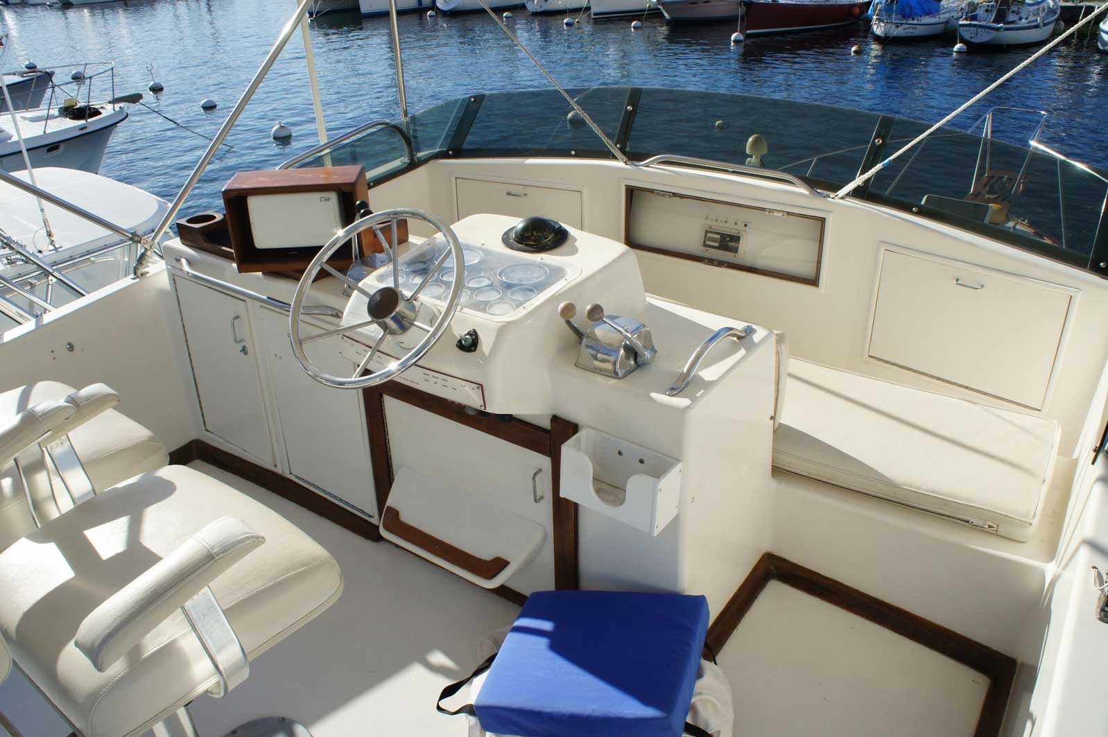 A boat is docked in a harbor with boats in the background.