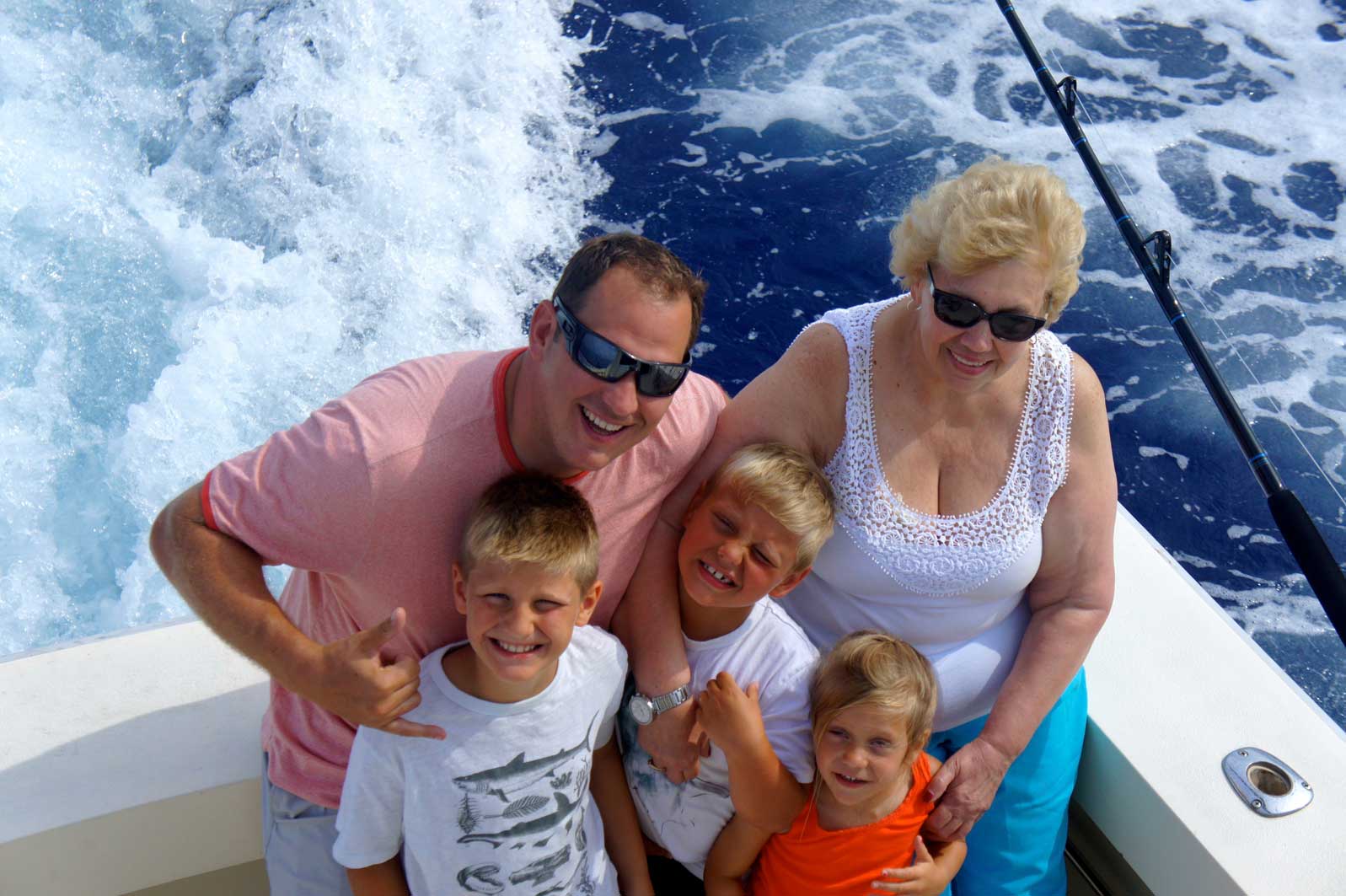 A family posing for a picture on a boat in the ocean
