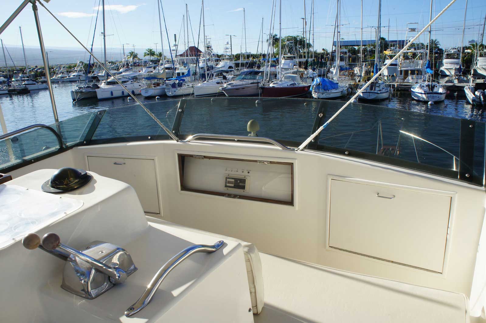 A boat is docked in a marina with many boats in the water.