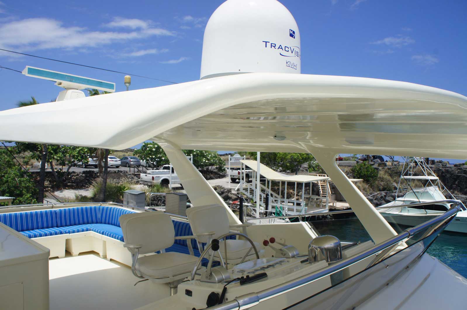 A white boat with a radar on top of it