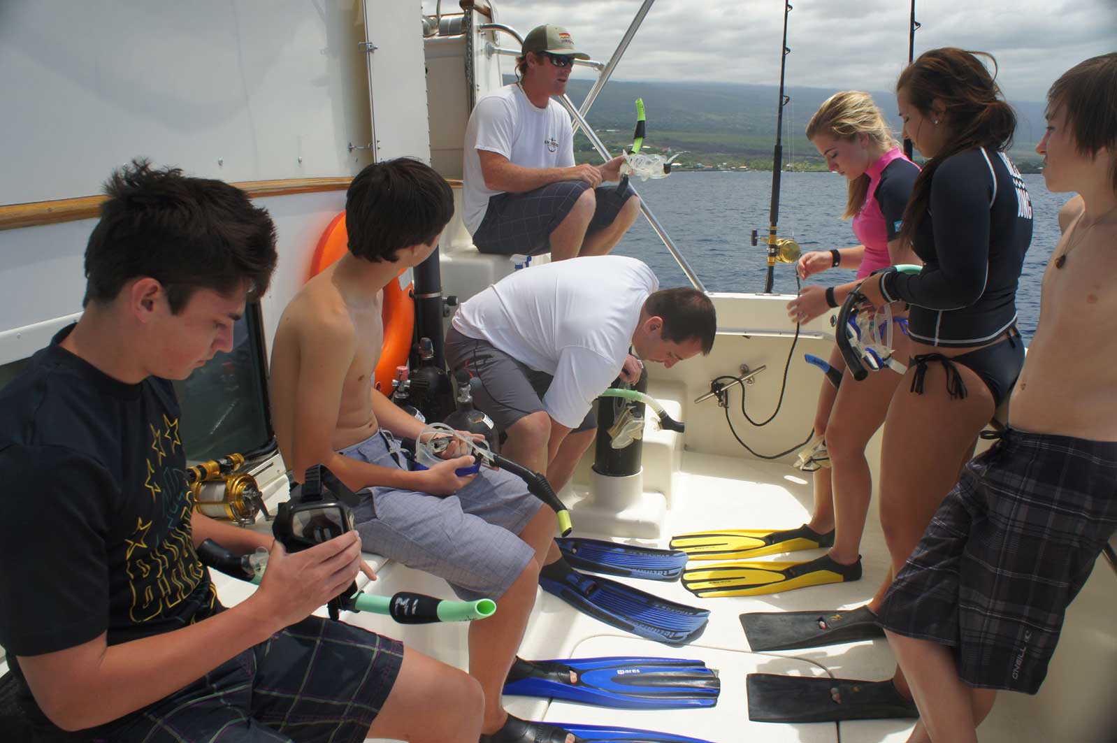 A group of people on a boat getting ready to go scuba diving