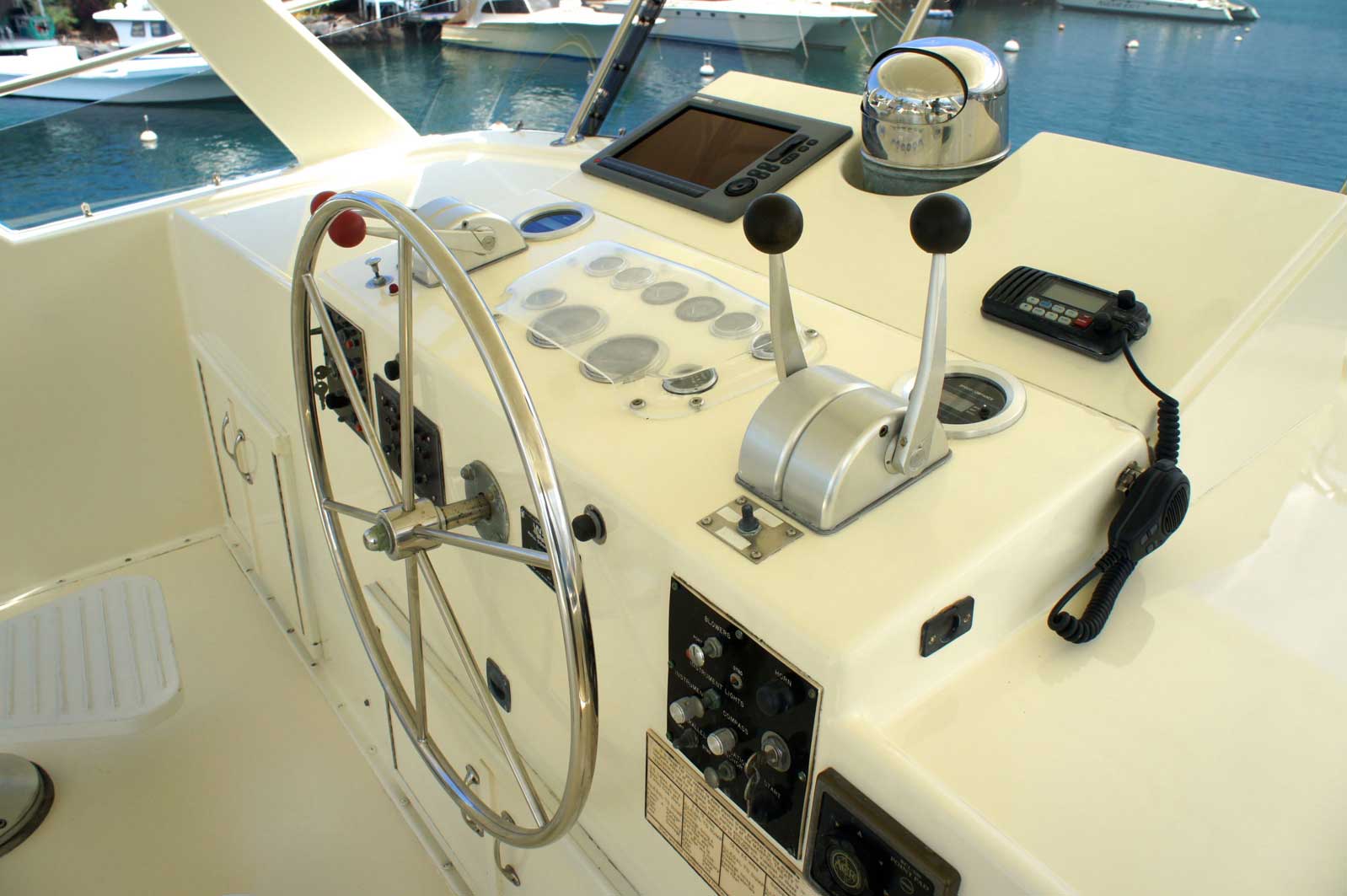 A boat 's steering wheel and control panel are shown