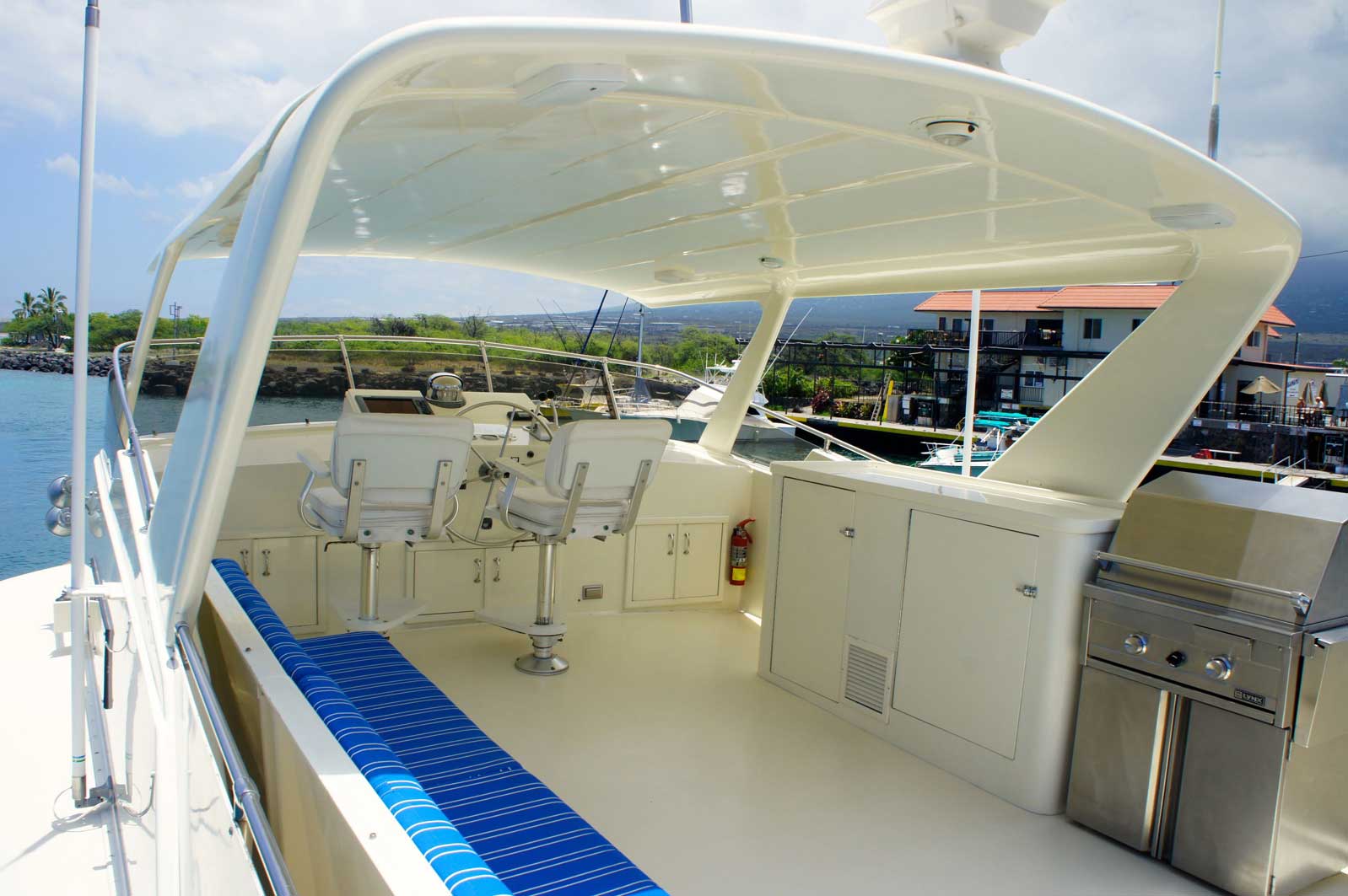 A white boat with a stainless steel grill on the deck