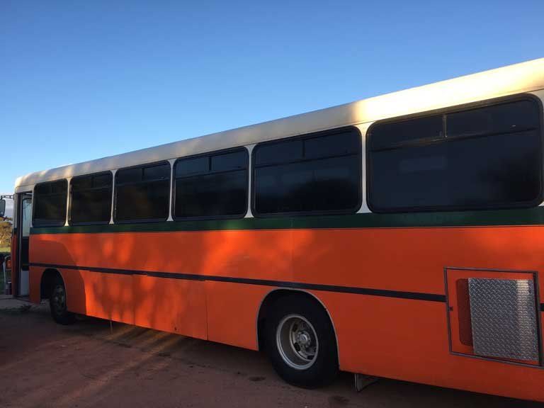 Orange bus with tinted windows