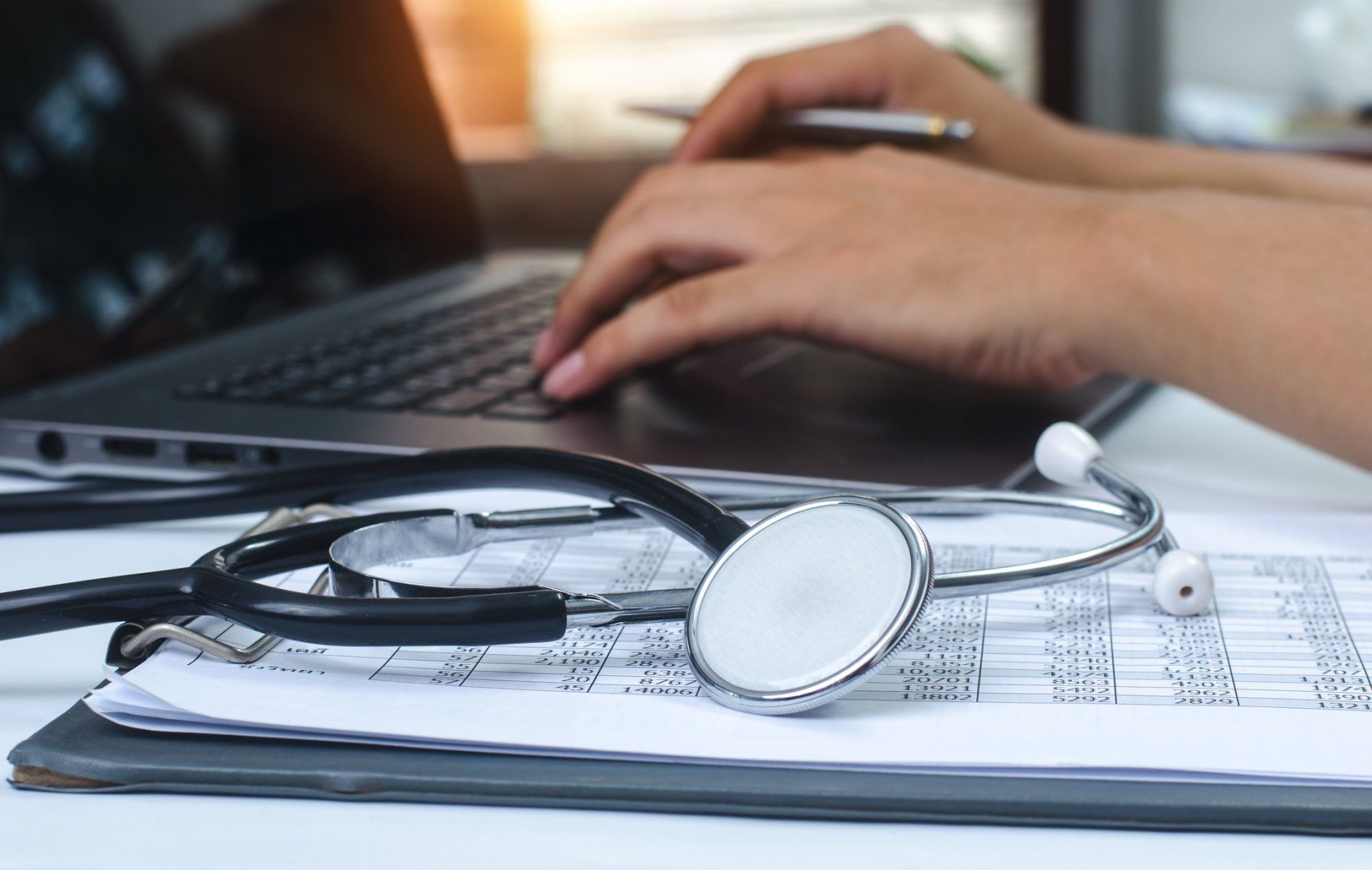 ADHD — Stethoscope Beside a Person Using a Laptop in Mobile, AL