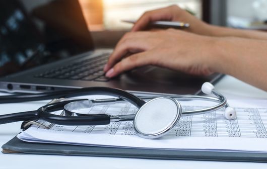 ADHD — Stethoscope Beside a Person Using a Laptop in Mobile, AL