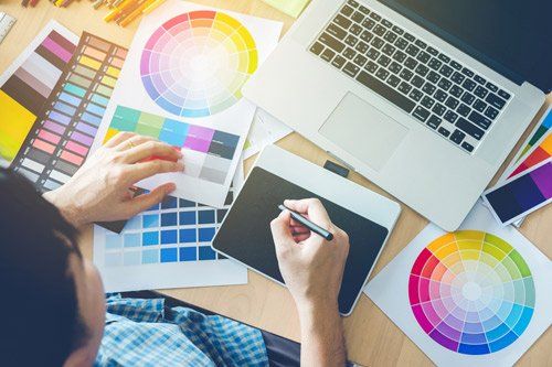 Graphic designer drawing on graphics tablet at workplace