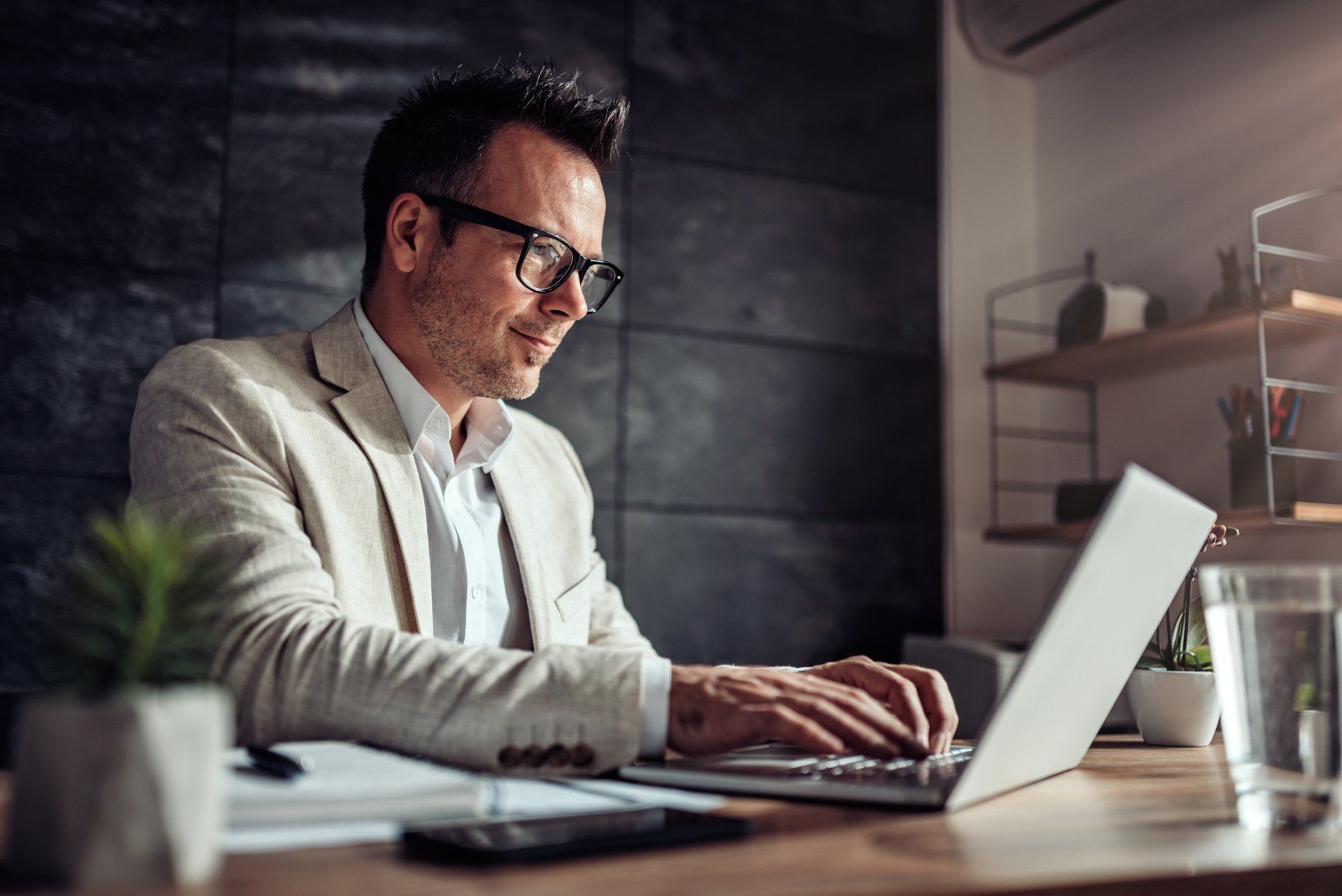 Accounting — Businessman Sitting at His Desk in the Office in Latham, NY Accounting — Businessman Sitting at His Desk in the Office in Latham, NY