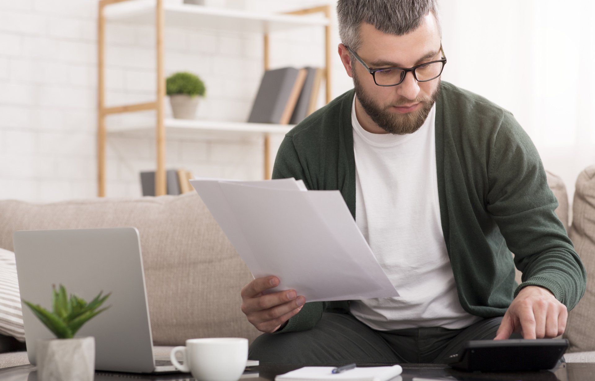 Auditing Services — Man Checking Bills at Home in Latham, NY Auditing Services — Man Checking Bills at Home in Latham, NY