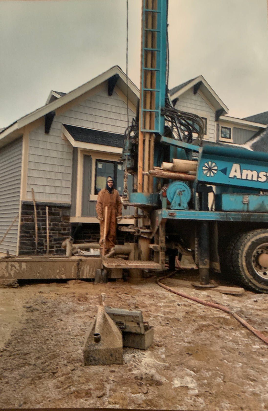 Man Standing Beside a Drilling Truck — Northeast, IN — Amstutz Well Drilling Man Standing Beside a Drilling Truck — Northeast, IN — Amstutz Well Drilling