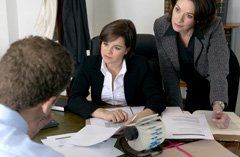 two professional women counseling a man