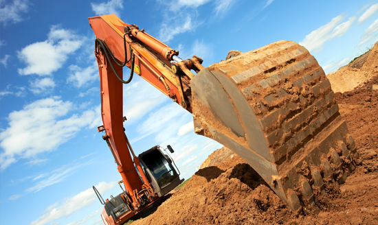 track-type loader excavator machine doing earthmoving work at sand quarry