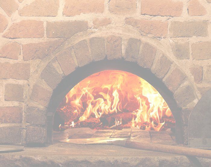 A brick oven with flames coming out of it