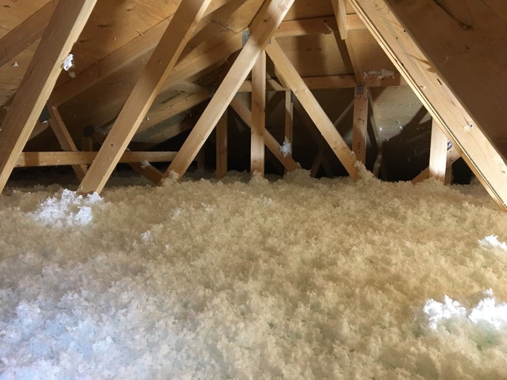 There is a lot of insulation in the attic of a house.