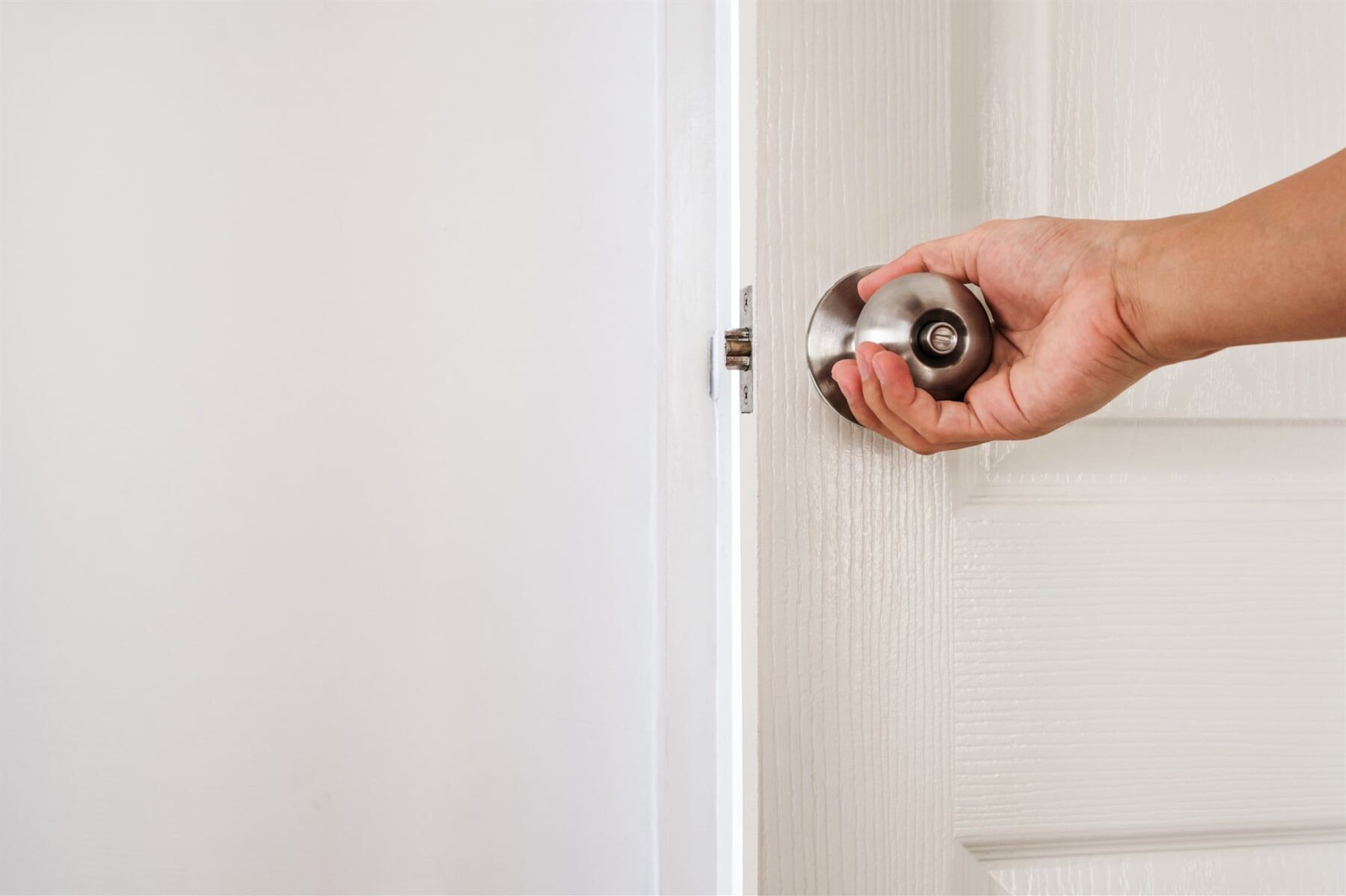 Hand Holding A Door Knob — Affordable Doors & Wardrobes in Wodonga