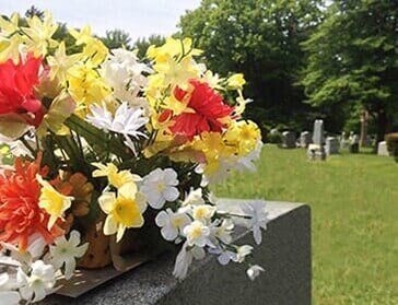 Flowers on Top a Tombstone - Funeral Services in Brooklyn NY Flowers on Top a Tombstone - Funeral Services in Brooklyn NY