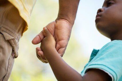 A Mother's and a child hands - Burial Services in Brooklyn, NY