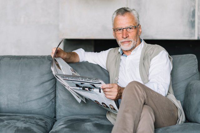 elderly man sitting and reading
