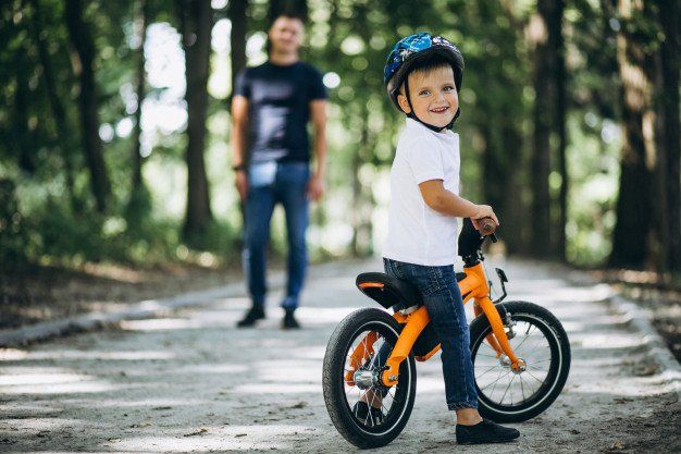 a boy biking with his father