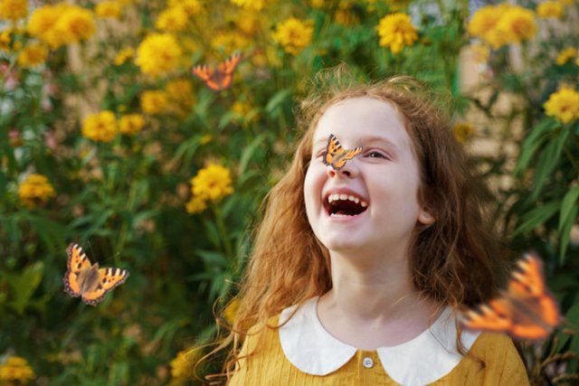 kid with butterfly in her nose