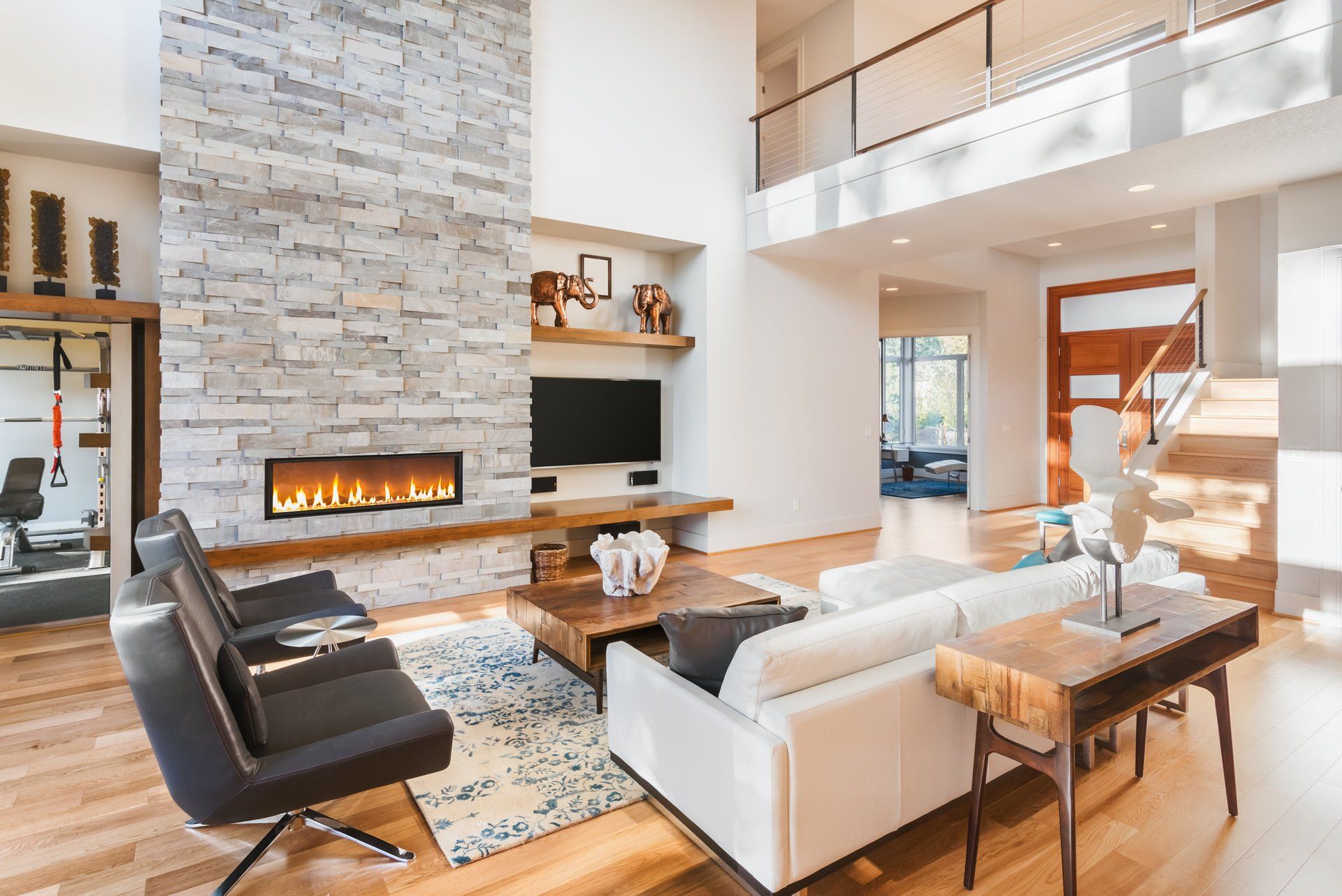 A living room with a couch , chair , table , fireplace and television.