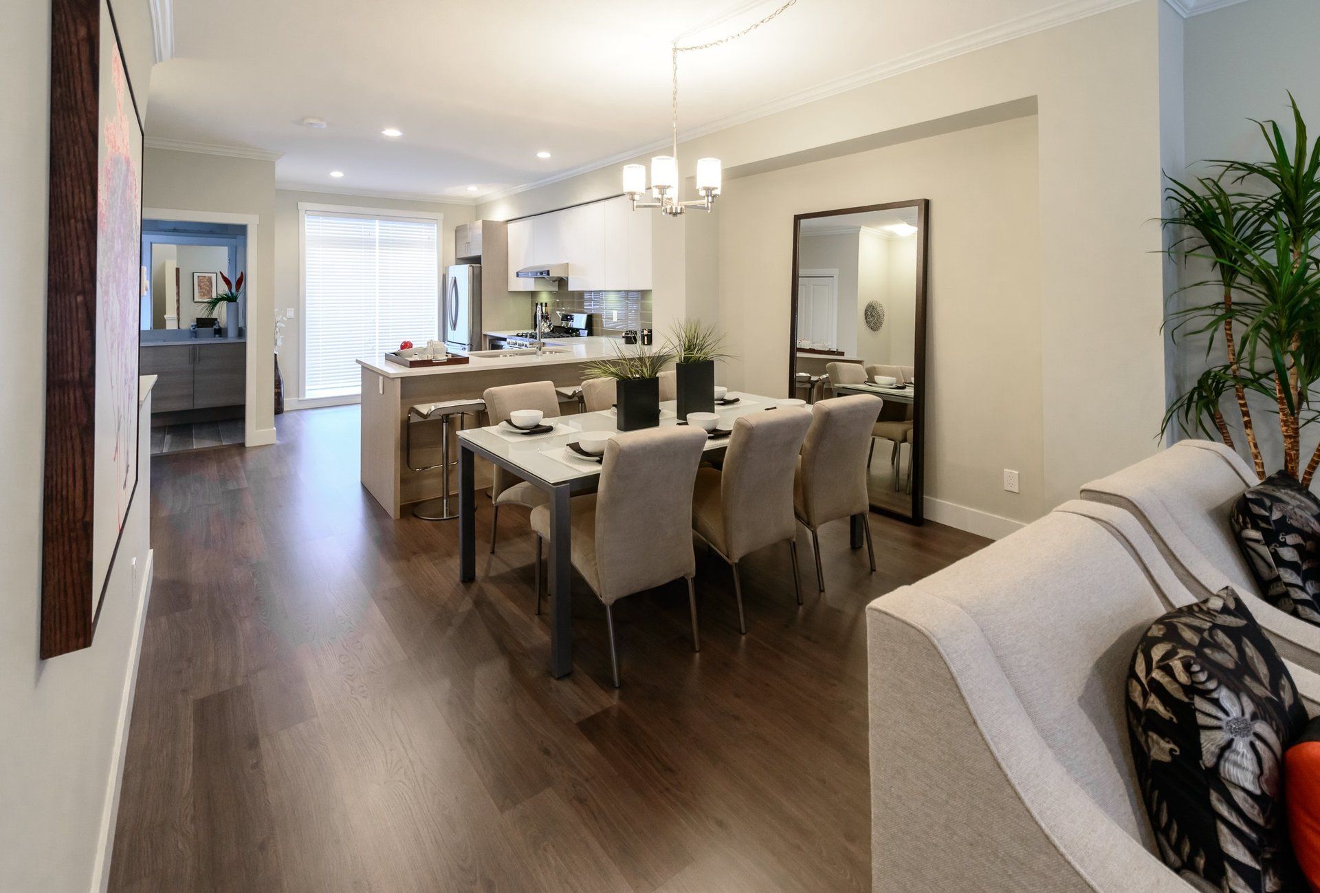 A living room with a dining table and chairs and a couch.