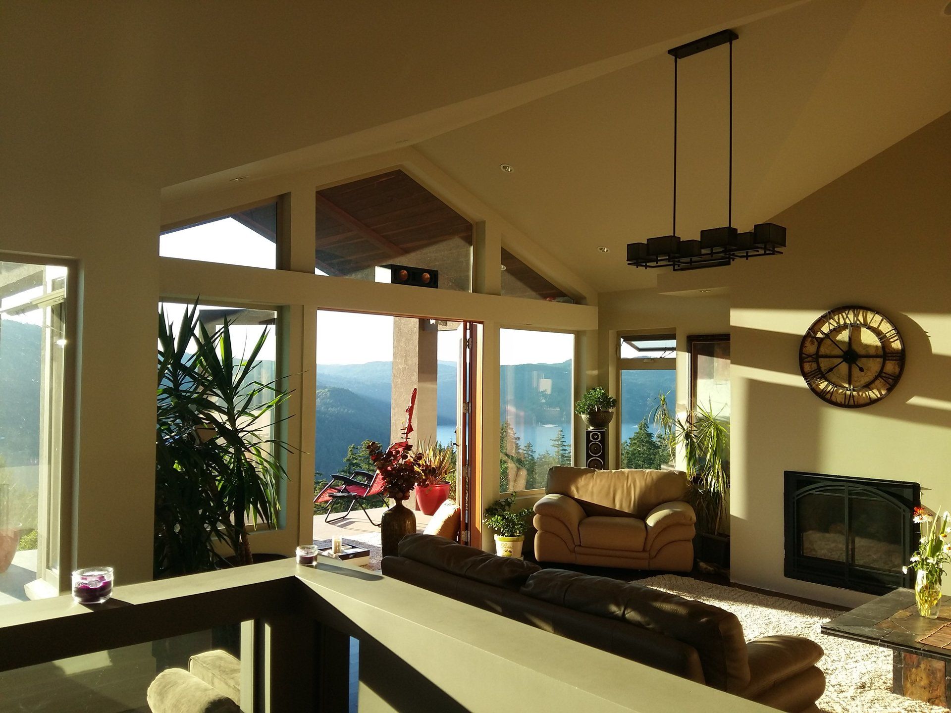 A living room with a lot of windows and a fireplace