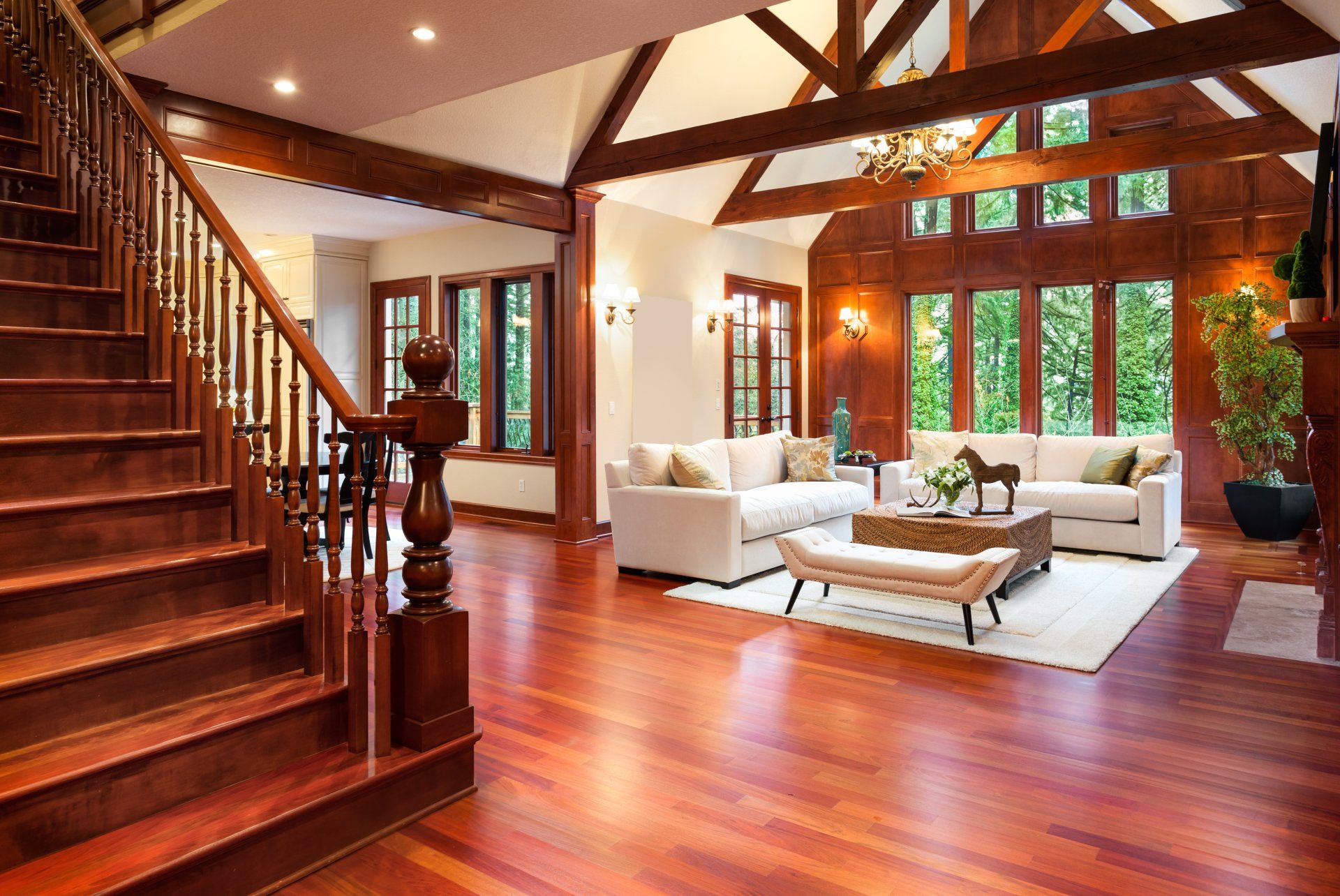 A living room with hardwood floors and stairs leading up to the second floor.