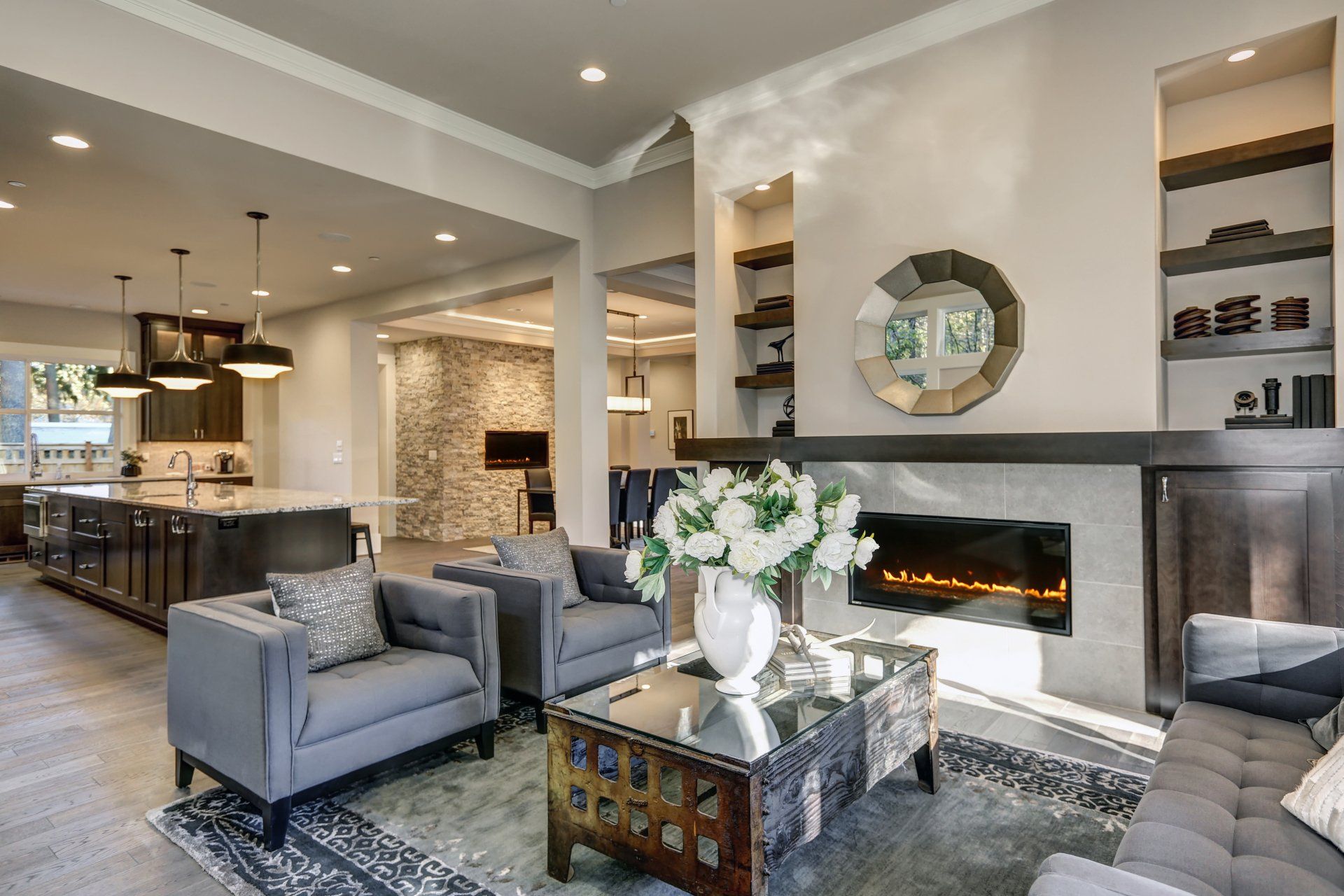 A living room with a couch , chairs , coffee table and fireplace.